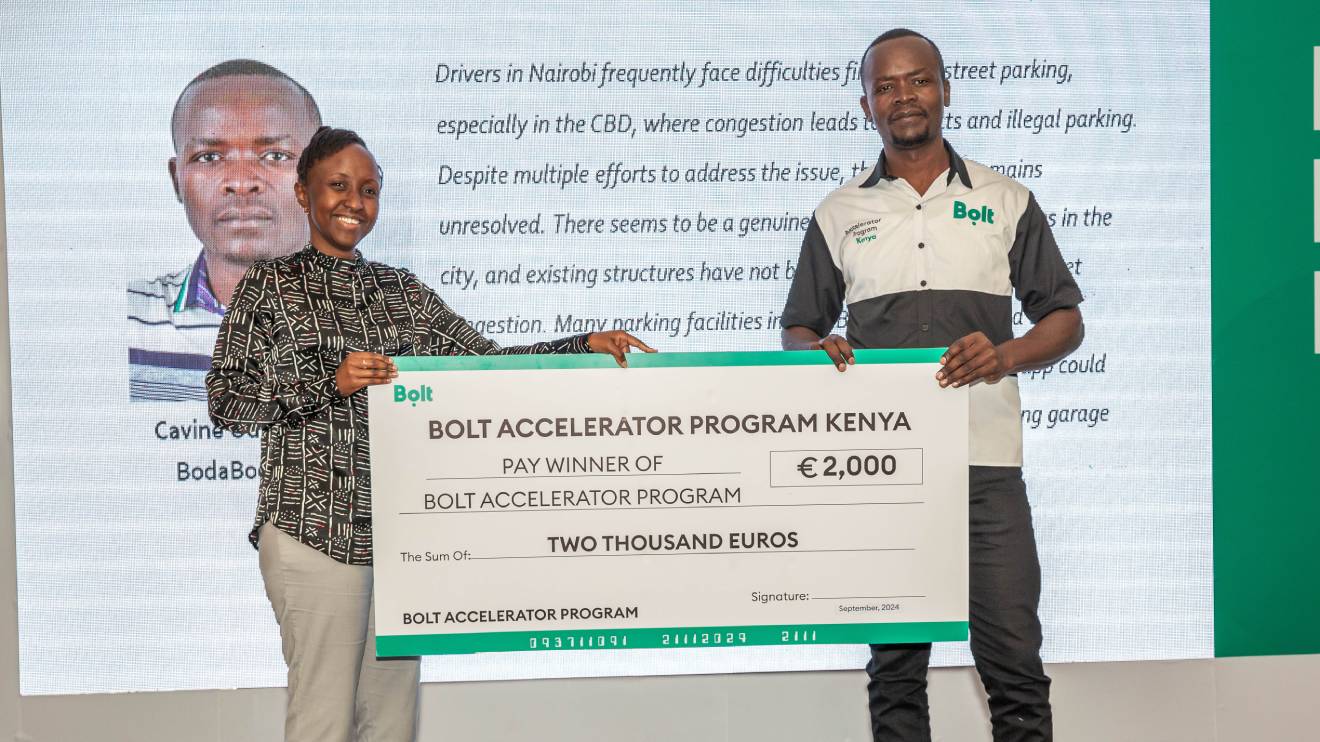 Linda Ndungu presenting a dummy cheque to a winner. PHOTO/COURTESY